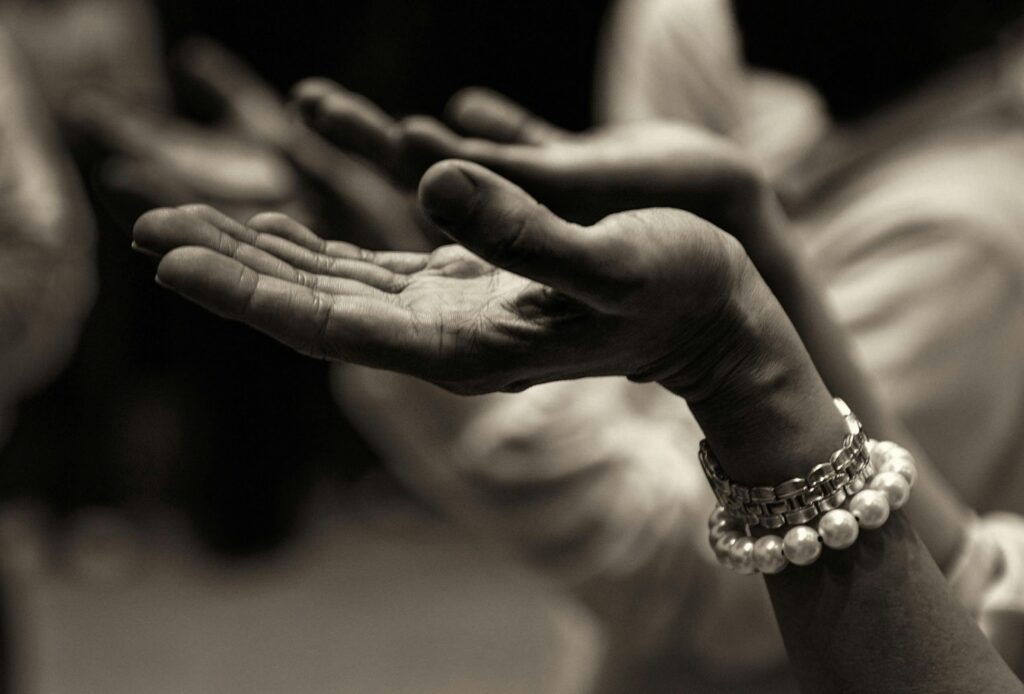 pexels-photo-257037-257037 Close-up of expressive hands in prayer wearing a bracelet, conveying faith and devotion.